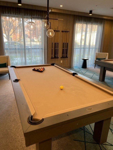 a pool table with a yellow ball on top of it