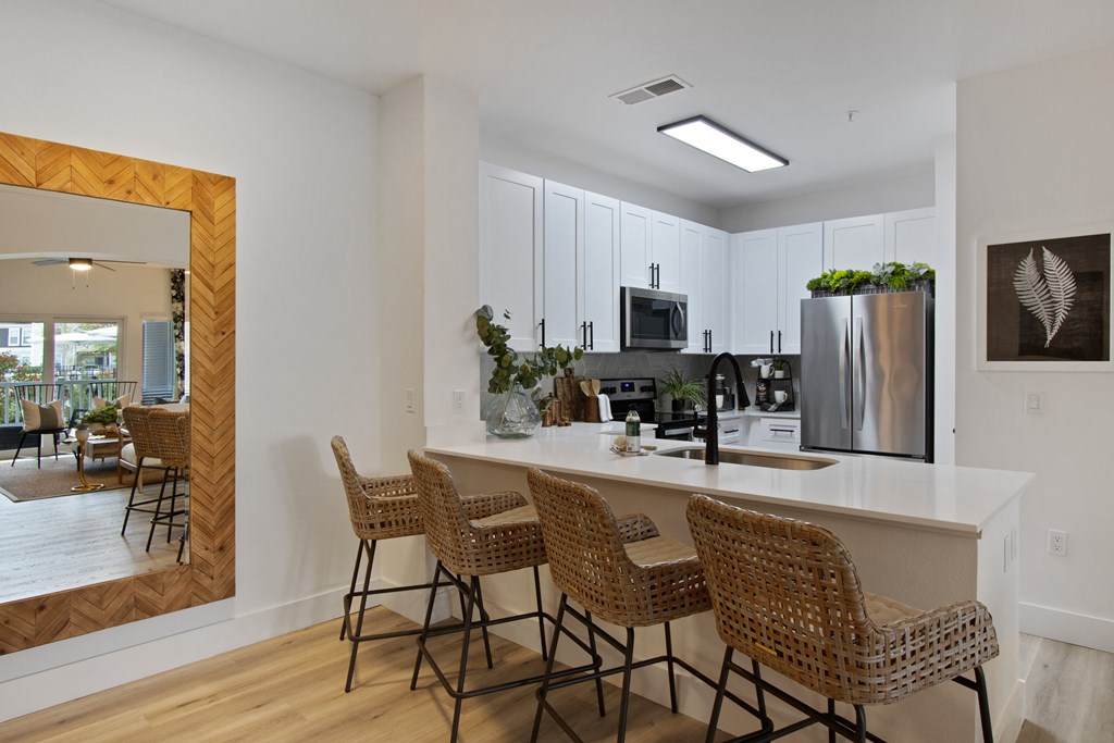 an open kitchen with a large island with bar stools