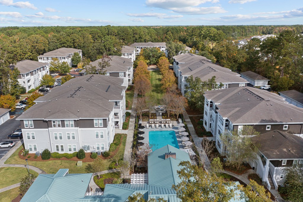 an aerial view of a neighborhood of houses with a swimming pool
