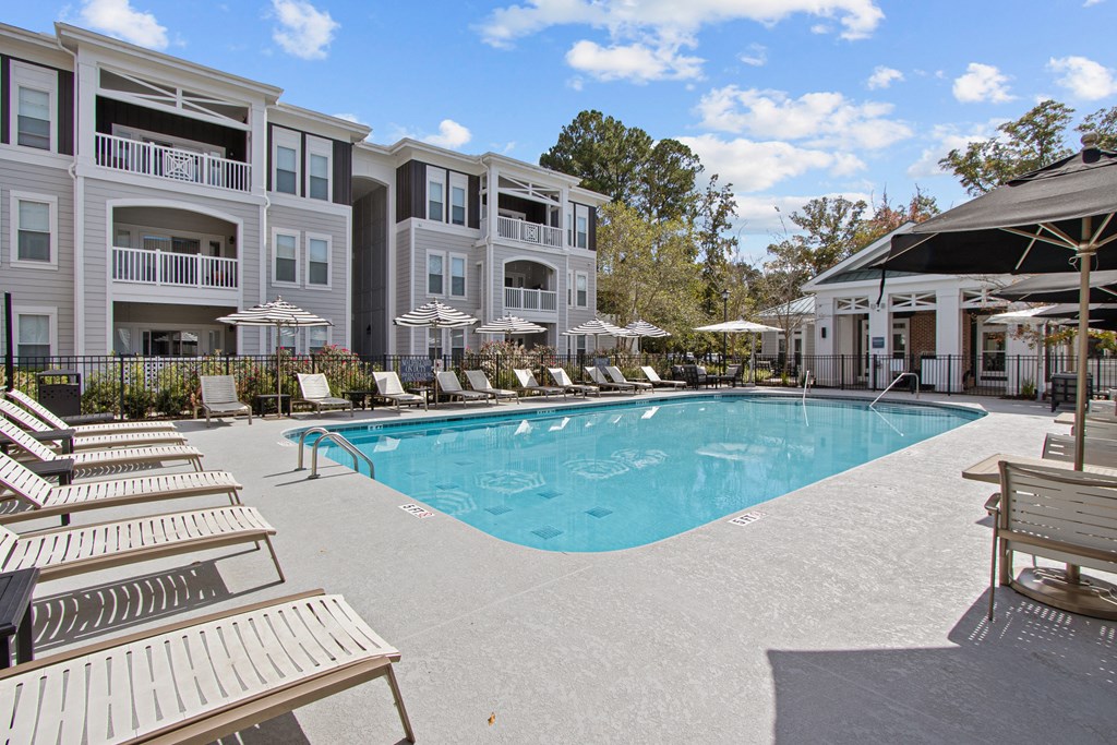 a large swimming pool in front of an apartment building