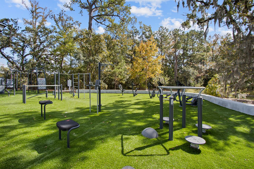a park with tables and chairs on the grass