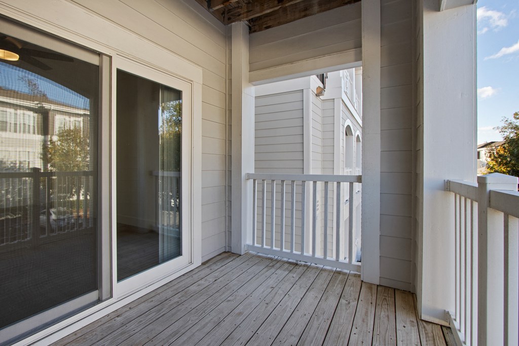 the deck of a home with sliding glass doors