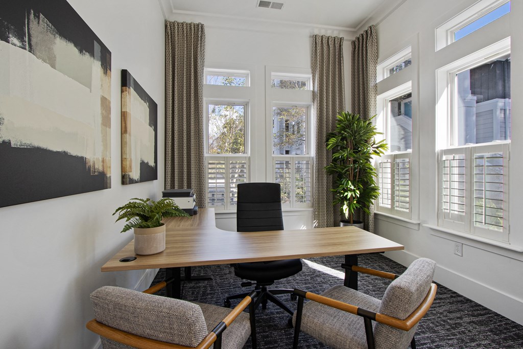 a conference room with a wooden table and chairs and windows
