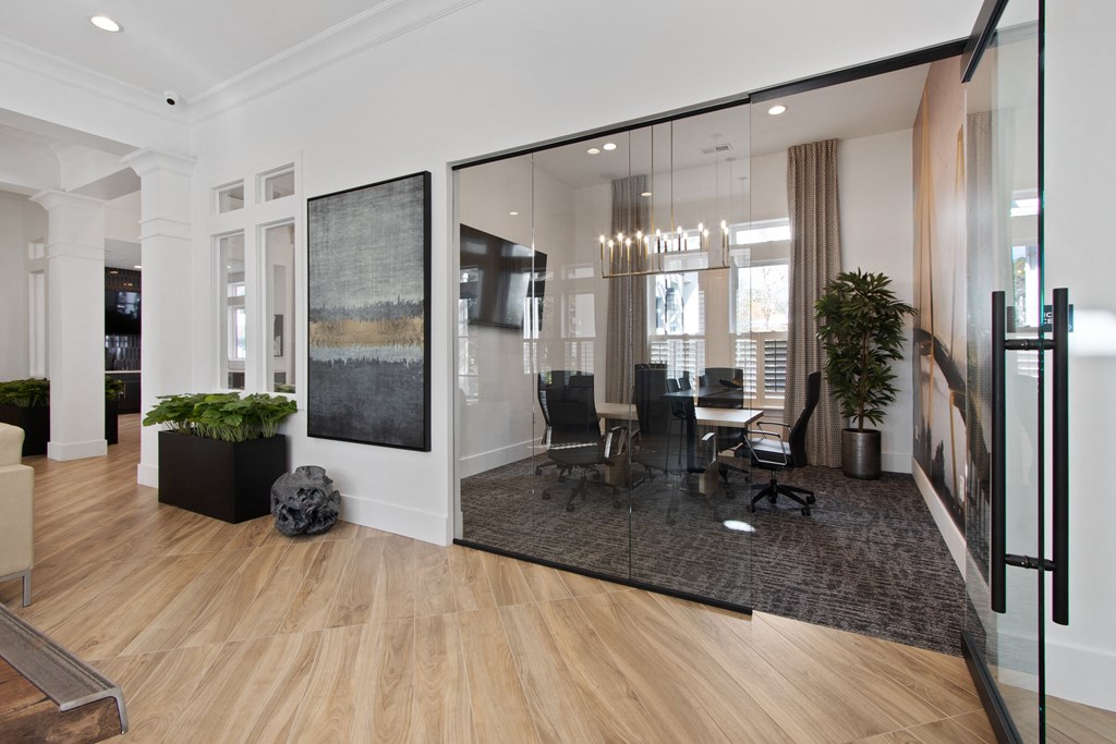 a conference room with glass walls and a table and chairs