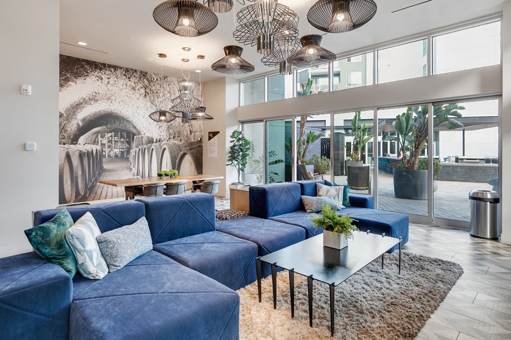 A living room with a blue couch and a coffee table.