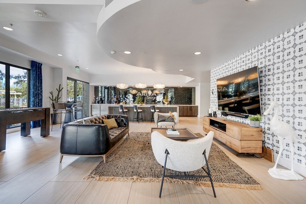 A modern living room with a black and white patterned wall.