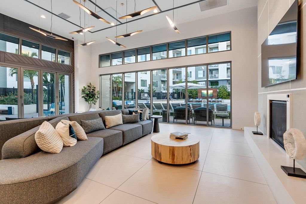 A modern living room with a curved sofa and a coffee table.