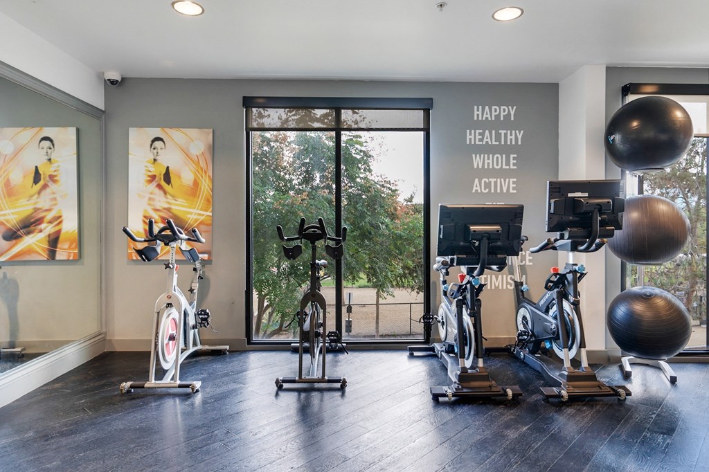 A gym with exercise equipment and a sign that says