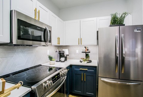 a kitchen with stainless steel appliances and white cabinets