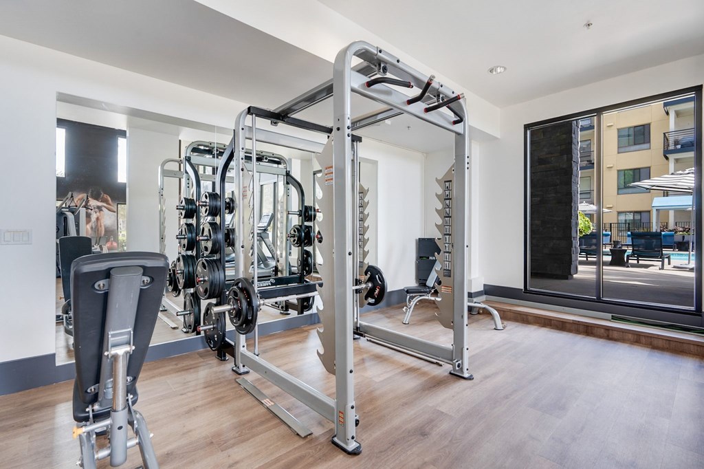 A gym with a variety of equipment including a leg press machine.
