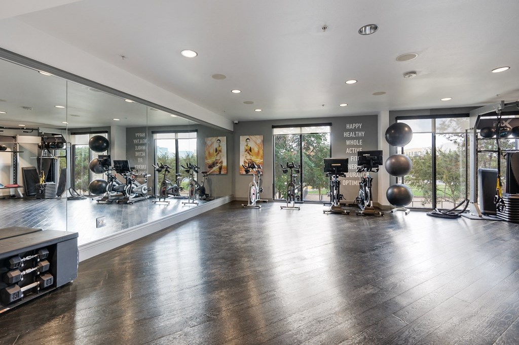 A gym with a variety of equipment and a sign that says