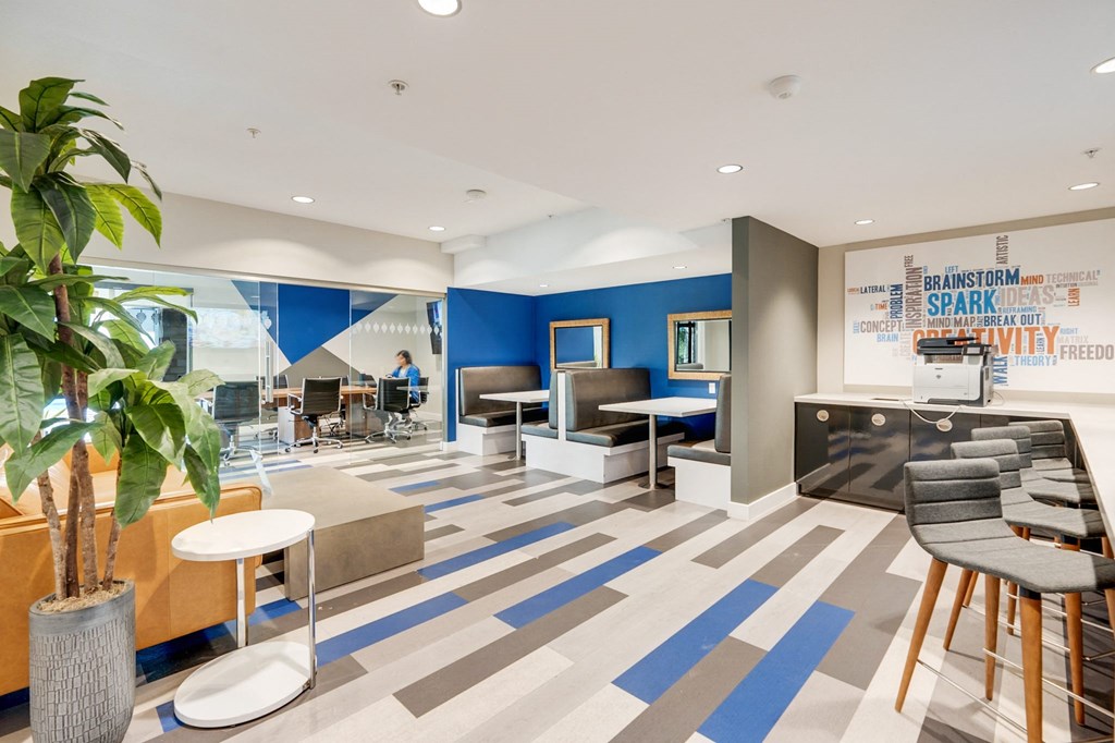 A modern office space with a blue and grey carpet.