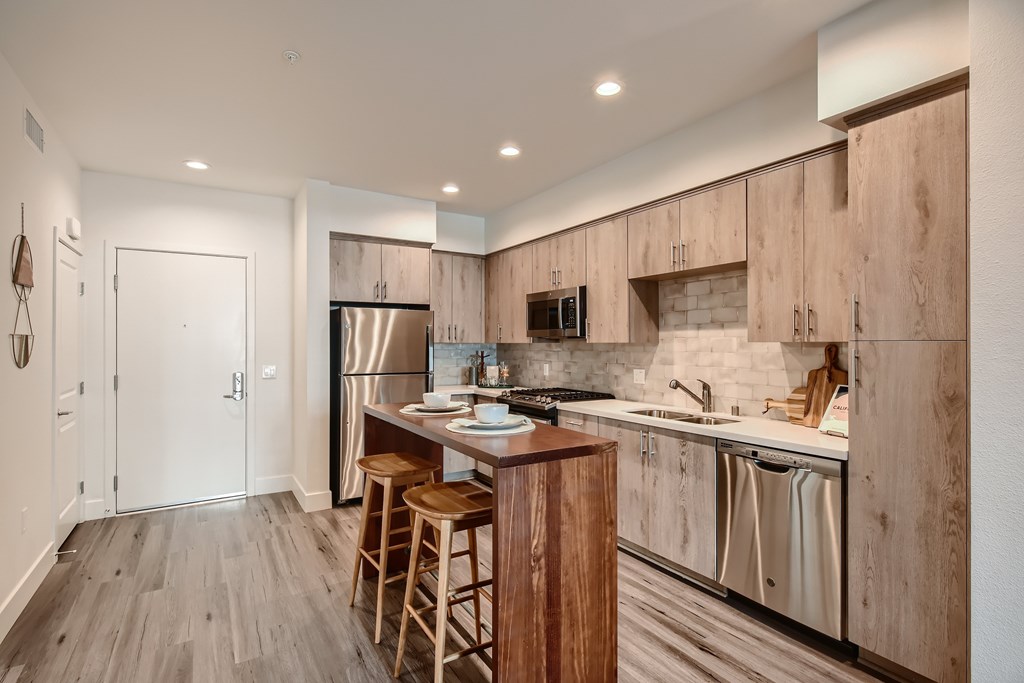 A kitchen with wooden cabinets and a white countertop.