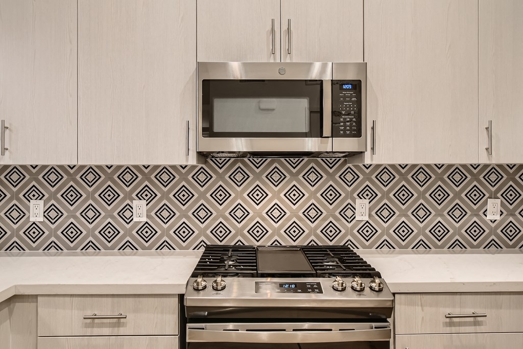 a kitchen with a stove and a microwave