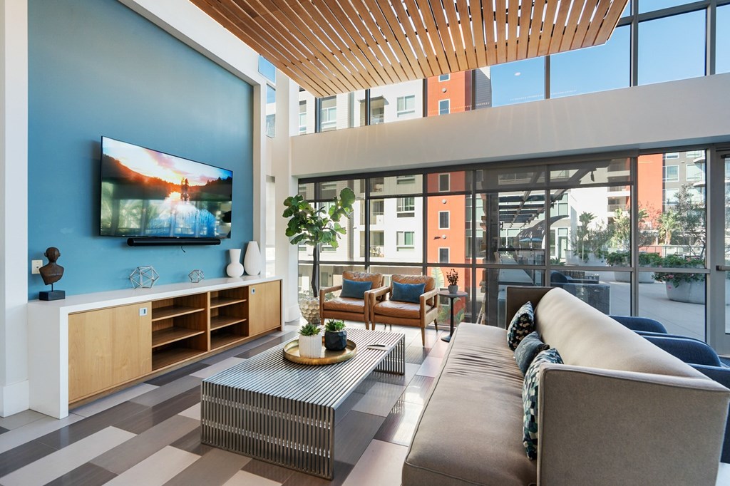 A modern living room with a flat screen TV on the wall.