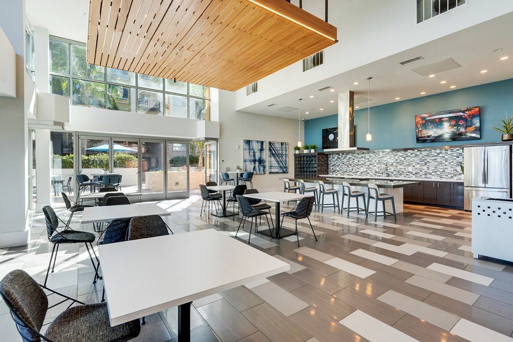 A modern dining room with a white table and chairs.