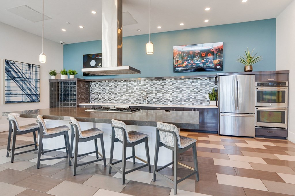 A kitchen with a stone backsplash and a refrigerator.