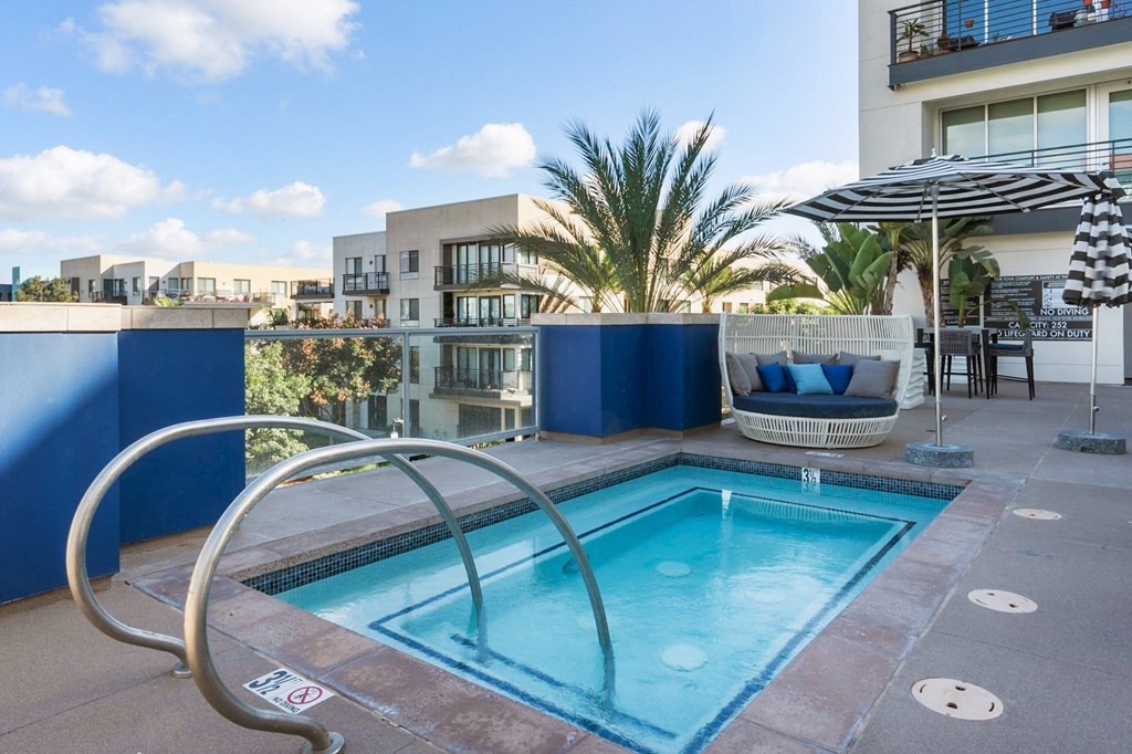 A small pool with a metal railing around it.