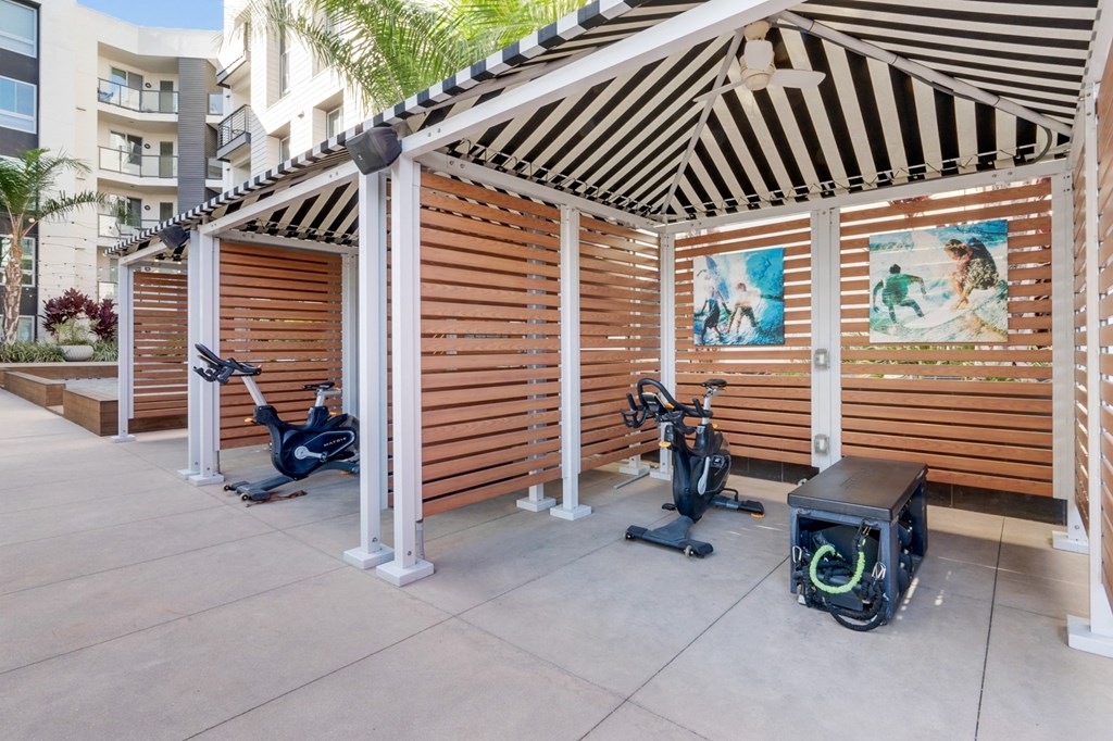 A wooden structure with exercise equipment inside.