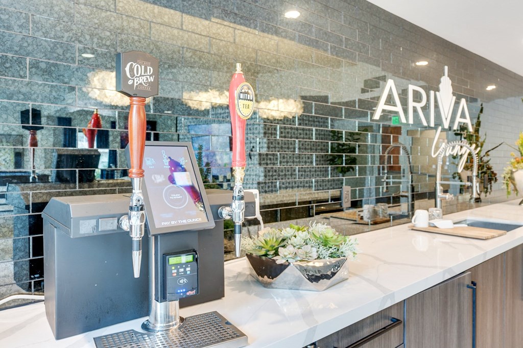 A modern bar with a black and white color scheme and a digital beer tap.
