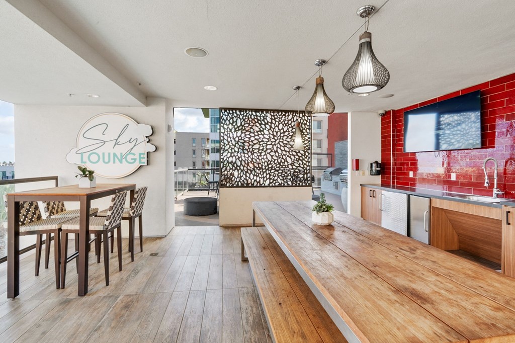 A modern dining area with a wooden table and chairs.