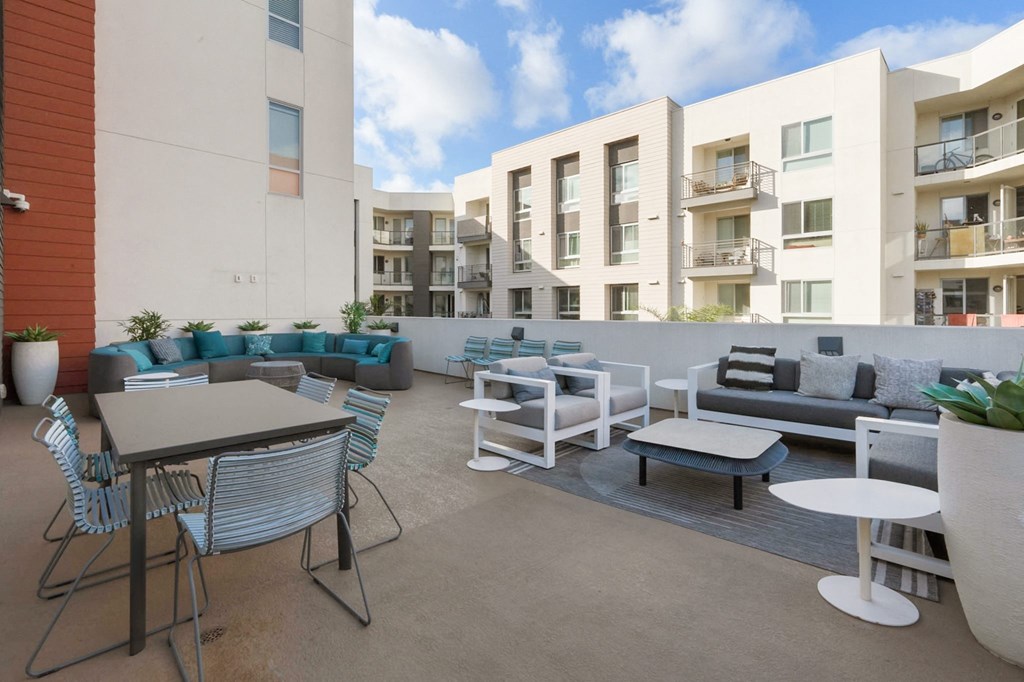 A patio with furniture and a table with a white background.