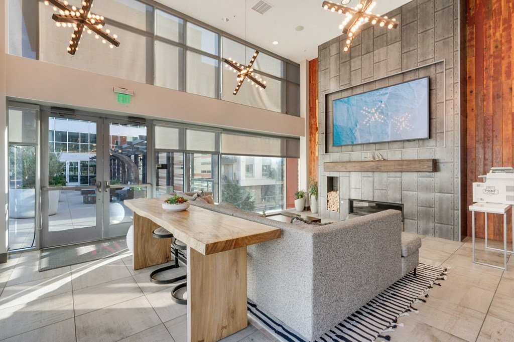 A modern kitchen with a wooden island and a large window.