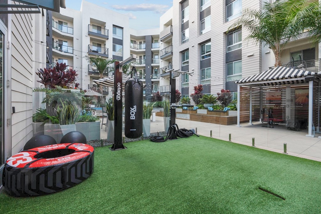 A black and red tire with the number 3 on it sits on a green artificial turf.