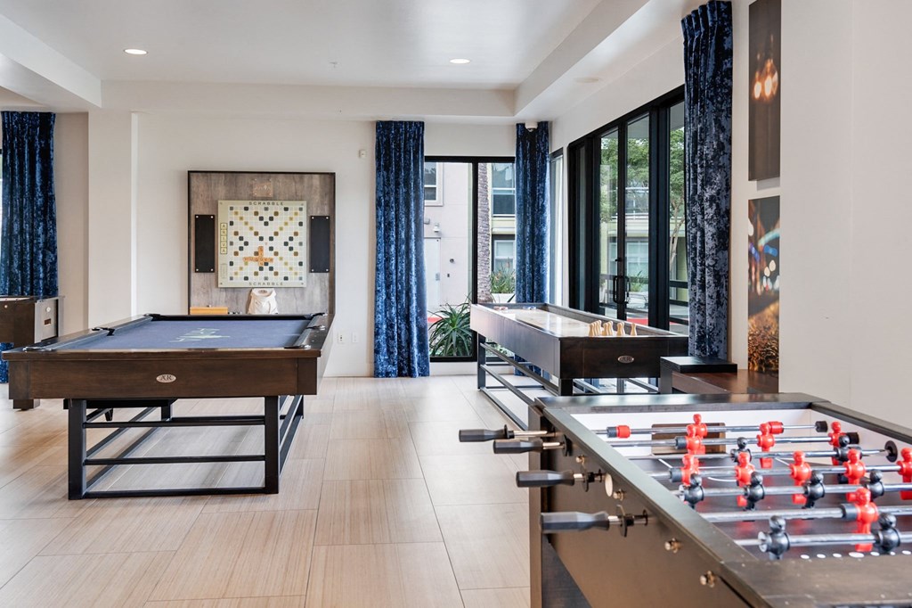 A foosball table is in a room with a pool table.