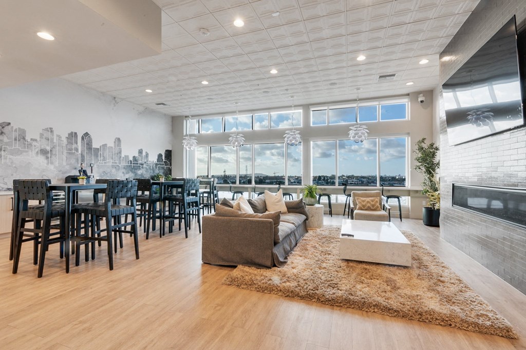 A spacious living room with a city skyline mural on the wall.