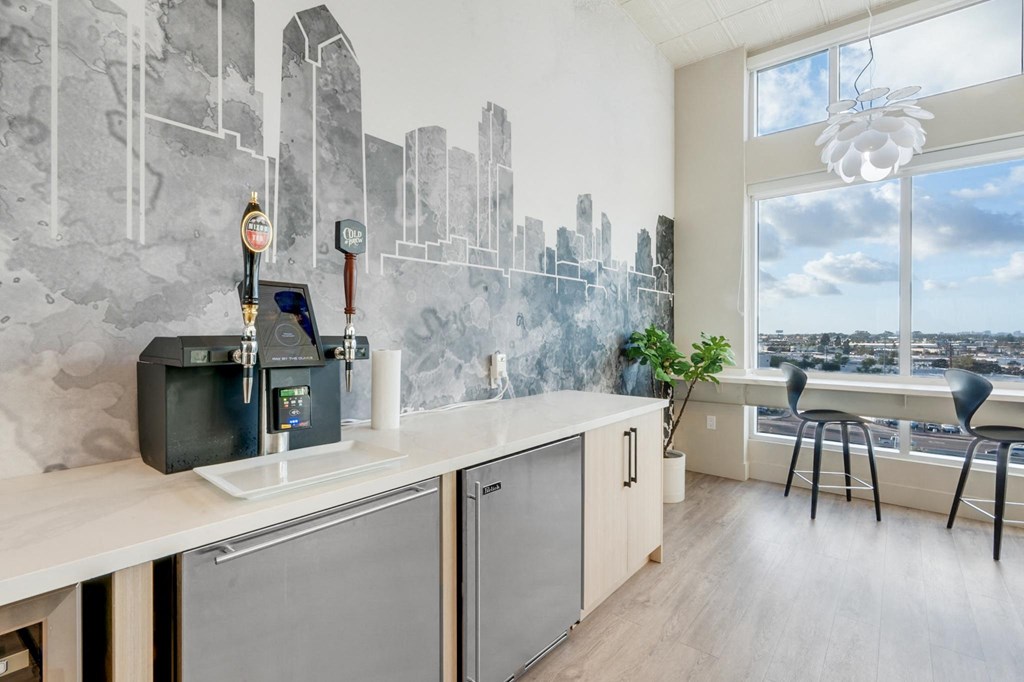 A modern kitchen with a cityscape mural on the wall.