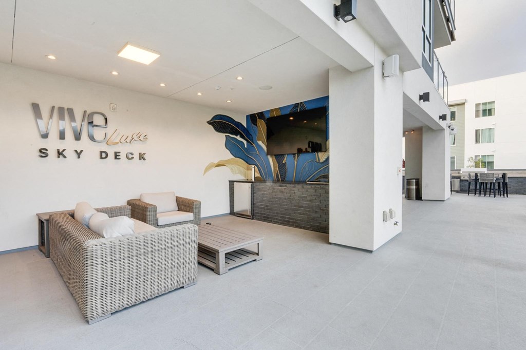 A modern living room with a sofa, armchair, and coffee table.