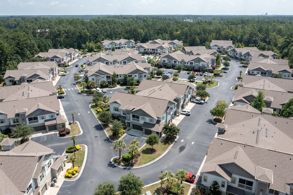 an aerial view of a neighborhood of houses with trees