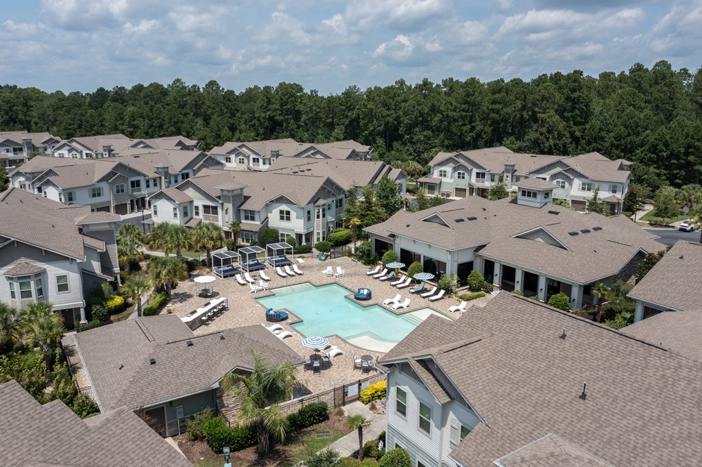 an aerial view of a swimming pool surrounded by houses