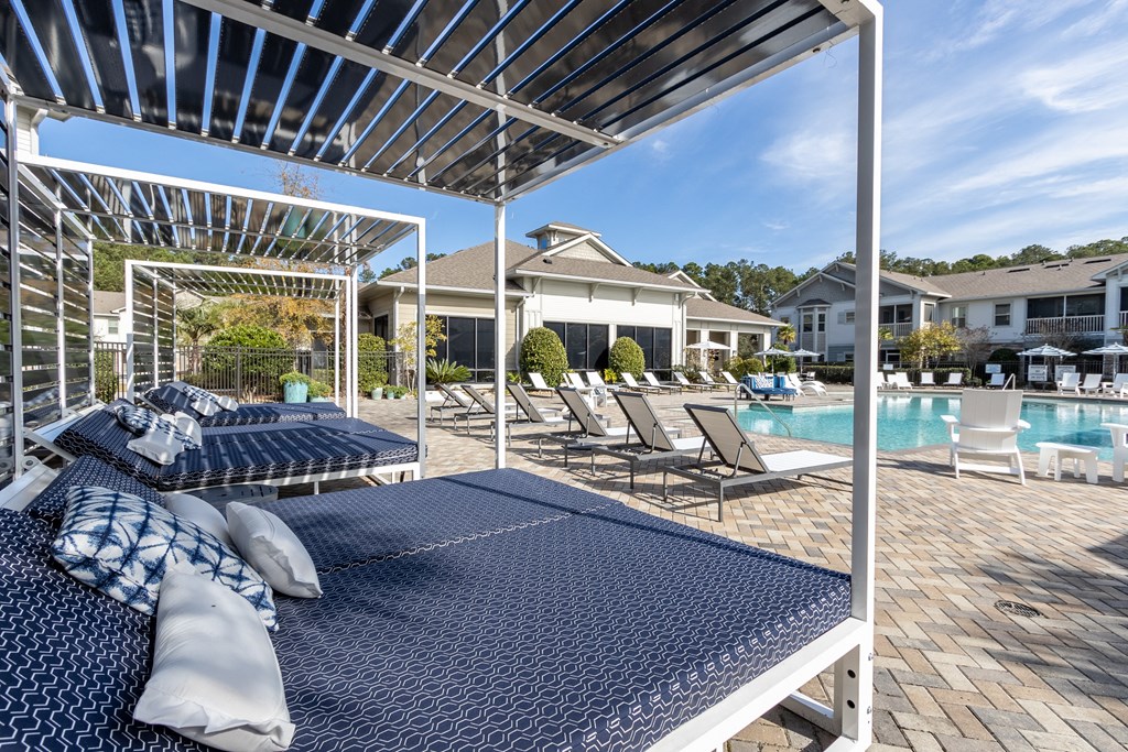 our resort style pool is equipped with lounge chairs and tables