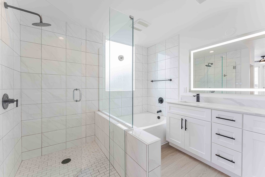 a white bathroom with a shower and a sink