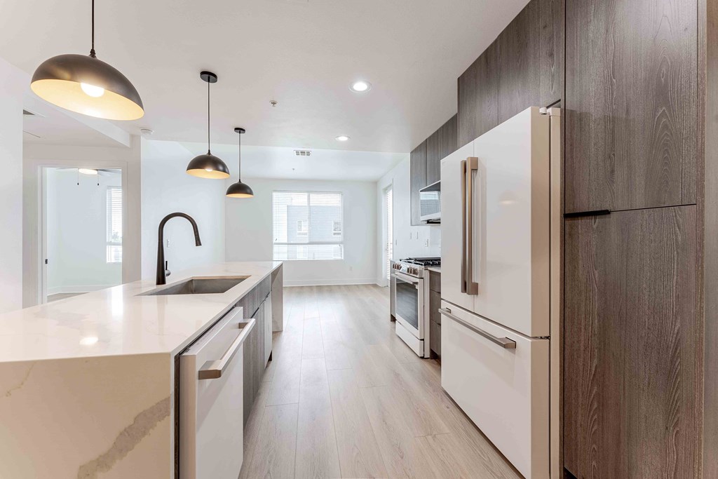 a kitchen with a sink and a refrigerator