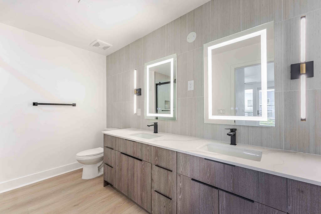 a bathroom with two sinks and a toilet