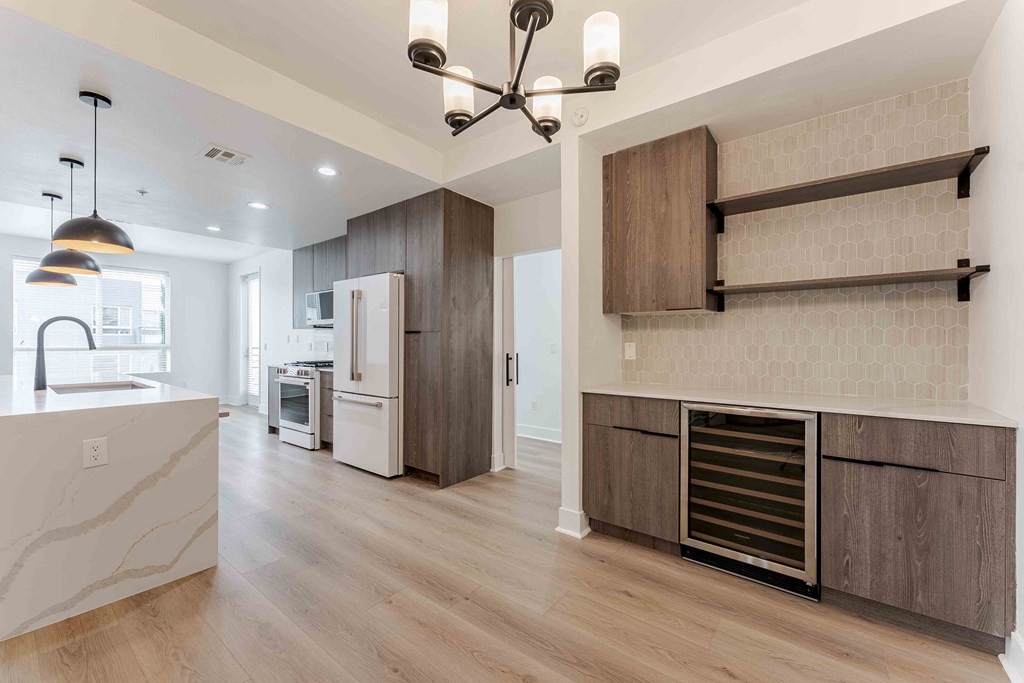 a kitchen with wooden cabinets and a white refrigerator