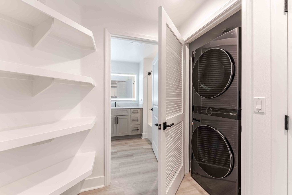 a laundry room with a closet and a washer and dryer