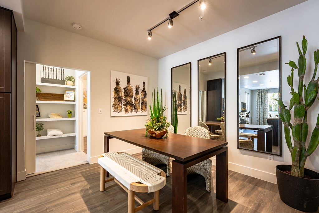a dining area with a wooden table and two chairs