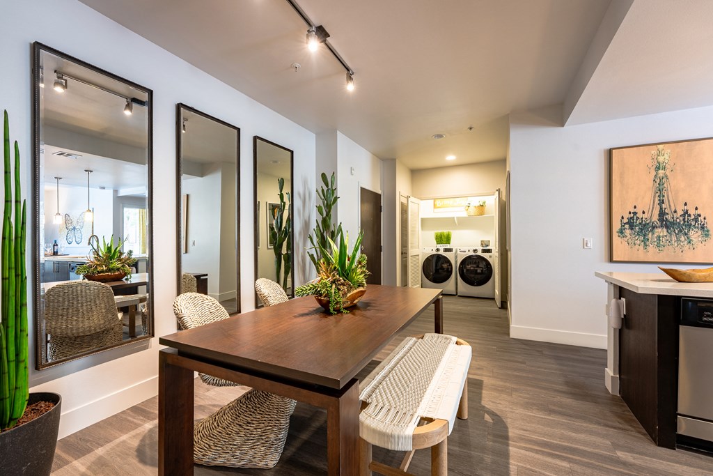 a dining area with a table and chairs and a laundry room with a washer and dry