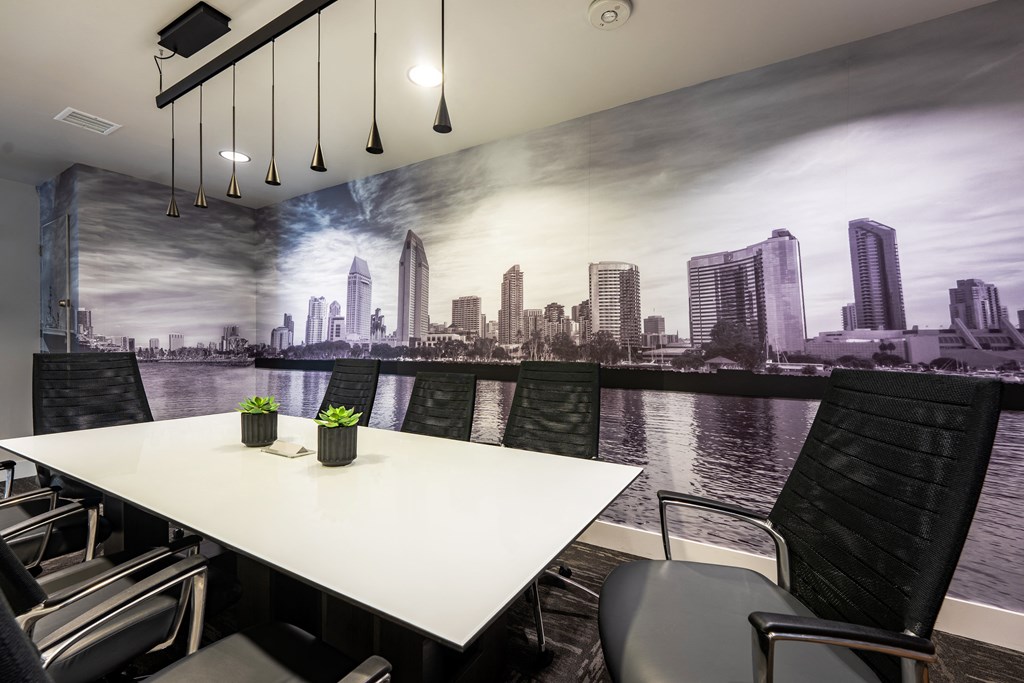 a meeting room with a large mural of a city on the wall