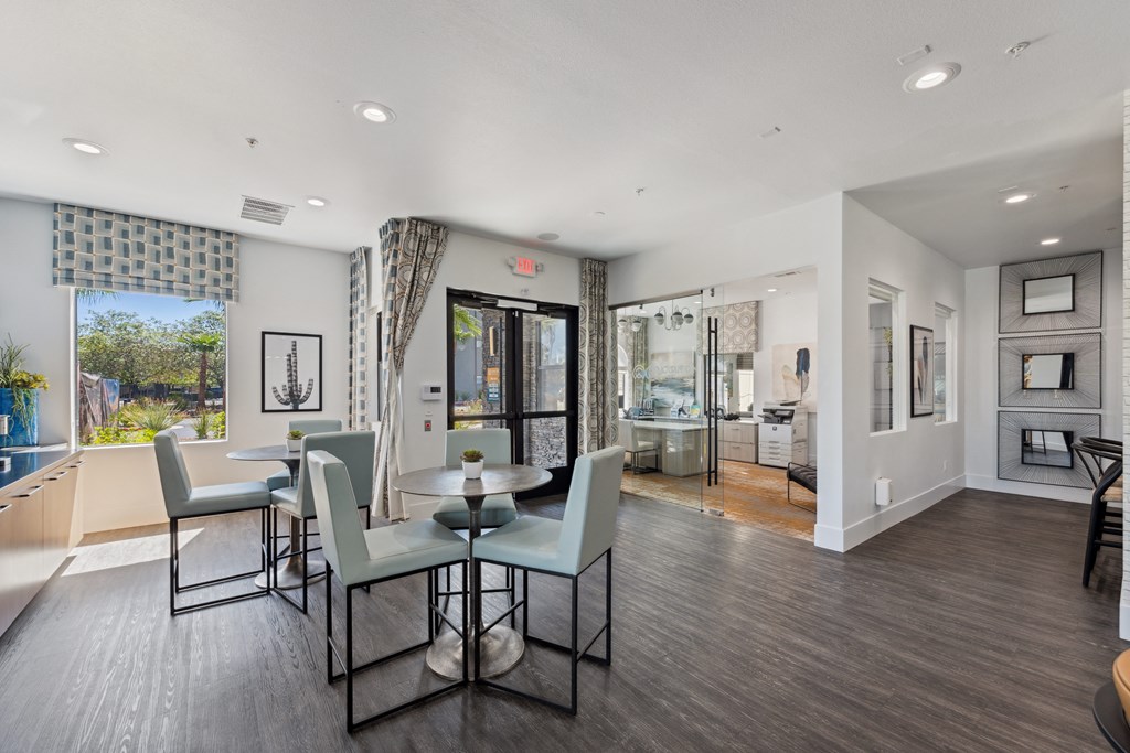 a living room with a dining room table and chairs and a kitchen