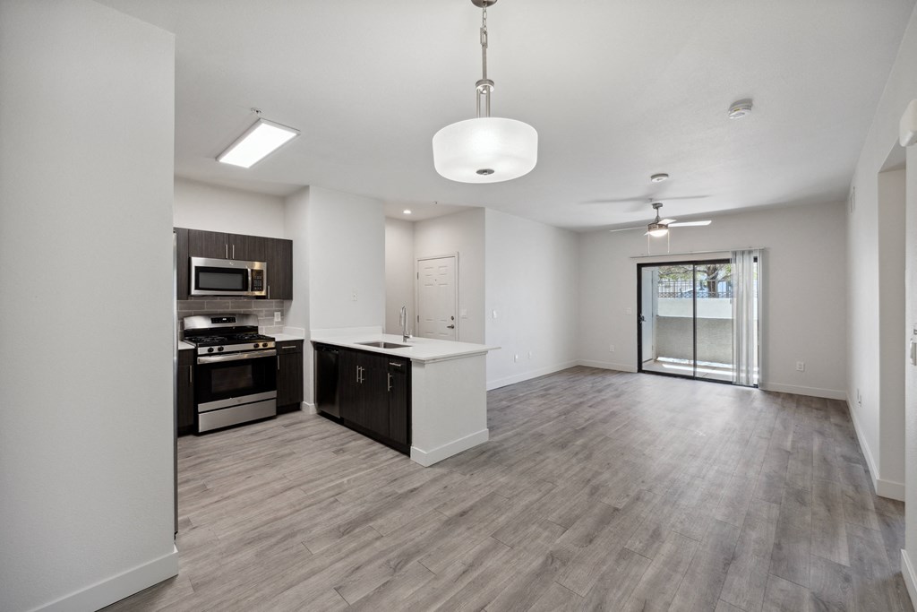 an empty kitchen and living room with an open floor plan