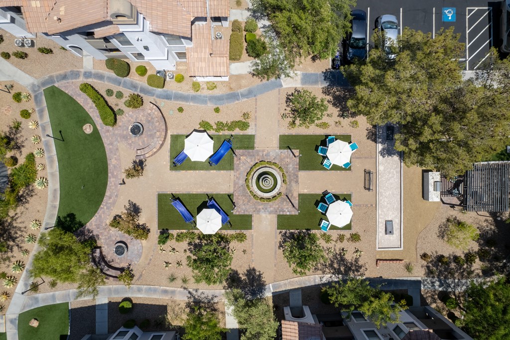 an aerial view of a park with lawns and trees