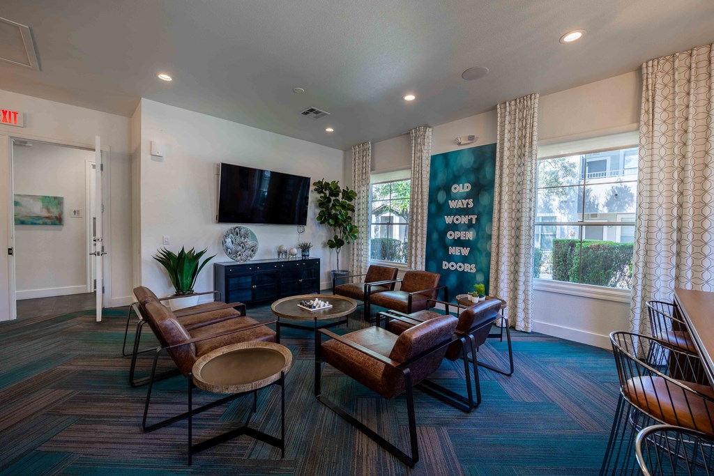 a living room with couches and chairs and a television