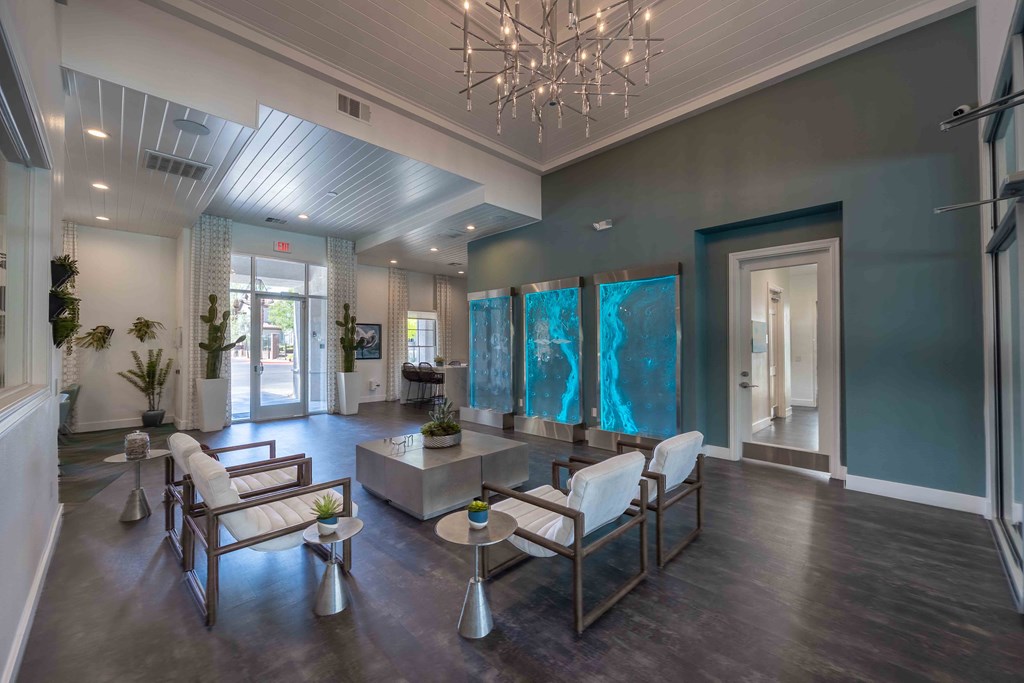 a large lobby with furniture and a chandelier