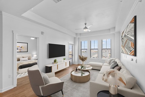 A living room with a television, a couch, a chair, and a coffee table.
