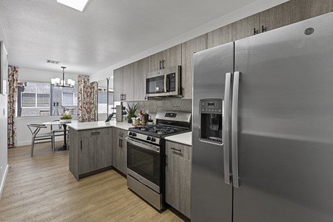 a kitchen with stainless steel appliances and a stainless steel refrigerator